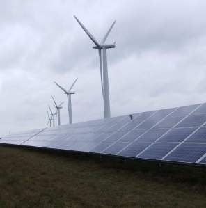 Ground based solar panels with wind turbines